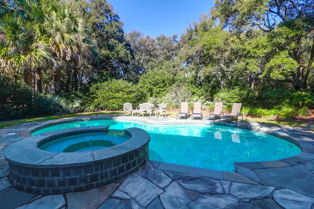 view of pool featuring an in ground hot tub and a patio