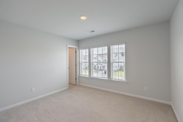 unfurnished room with light colored carpet