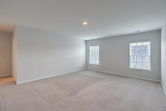 empty room with light colored carpet