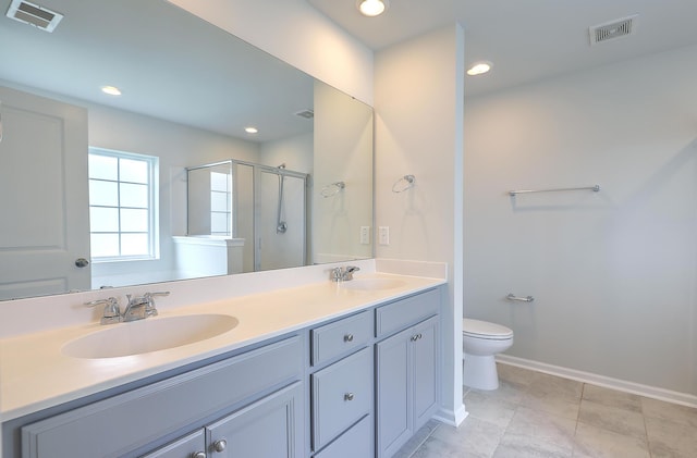 bathroom featuring vanity, toilet, and a shower with door