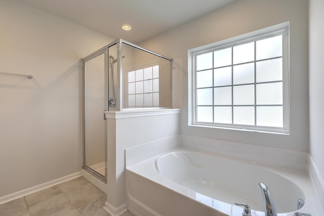 bathroom with separate shower and tub and tile patterned flooring