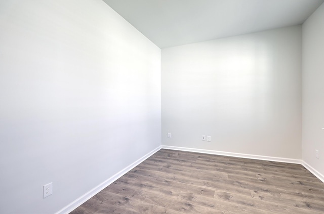 spare room with dark hardwood / wood-style floors