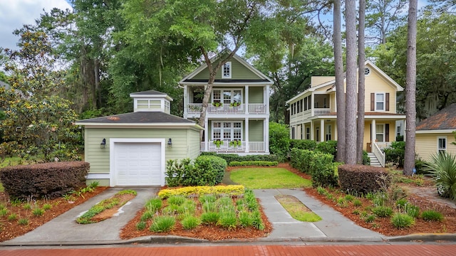 3221 Johnstowne St, Johns Island, SC 29455 - view of front of house featuring a balcony, a detached garage, and driveway