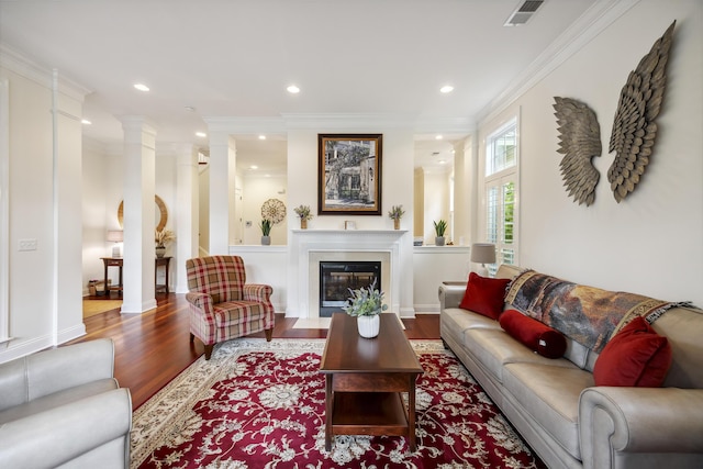 3221 Johnstowne St, Johns Island, SC 29455 - living room featuring wood finished floors, recessed lighting, ornamental molding, a glass covered fireplace, and ornate columns
