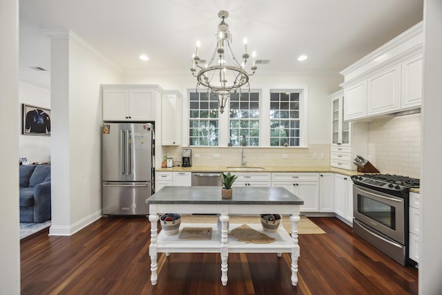 3221 Johnstowne St, Johns Island, SC 29455 - kitchen featuring appliances with stainless steel finishes, a chandelier, ornamental molding, dark wood-style floors, and white cabinetry