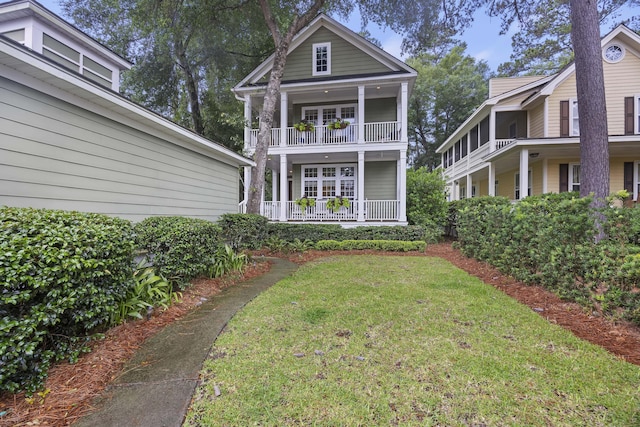 3221 Johnstowne St, Johns Island, SC 29455 - rear view of house featuring a porch, a lawn, and a balcony