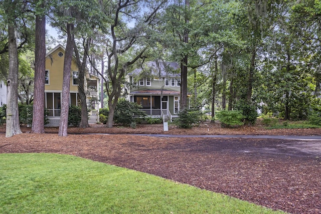 3221 Johnstowne St, Johns Island, SC 29455 - view of front facade featuring a sunroom and a front lawn