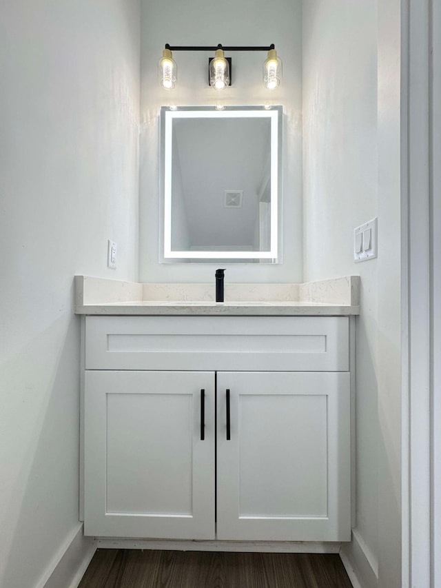 bathroom with hardwood / wood-style floors and vanity