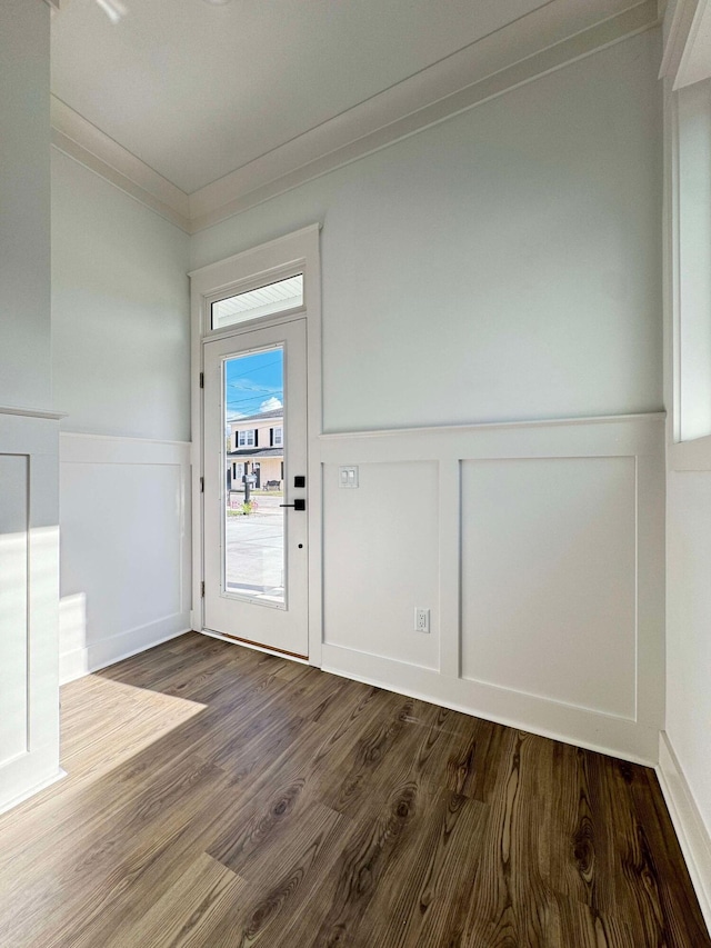 entrance foyer with crown molding and dark hardwood / wood-style floors