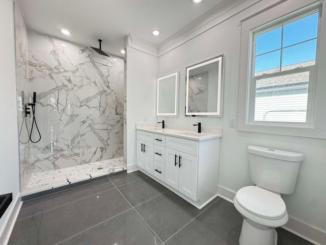 bathroom featuring tiled shower, vanity, tile patterned floors, and toilet