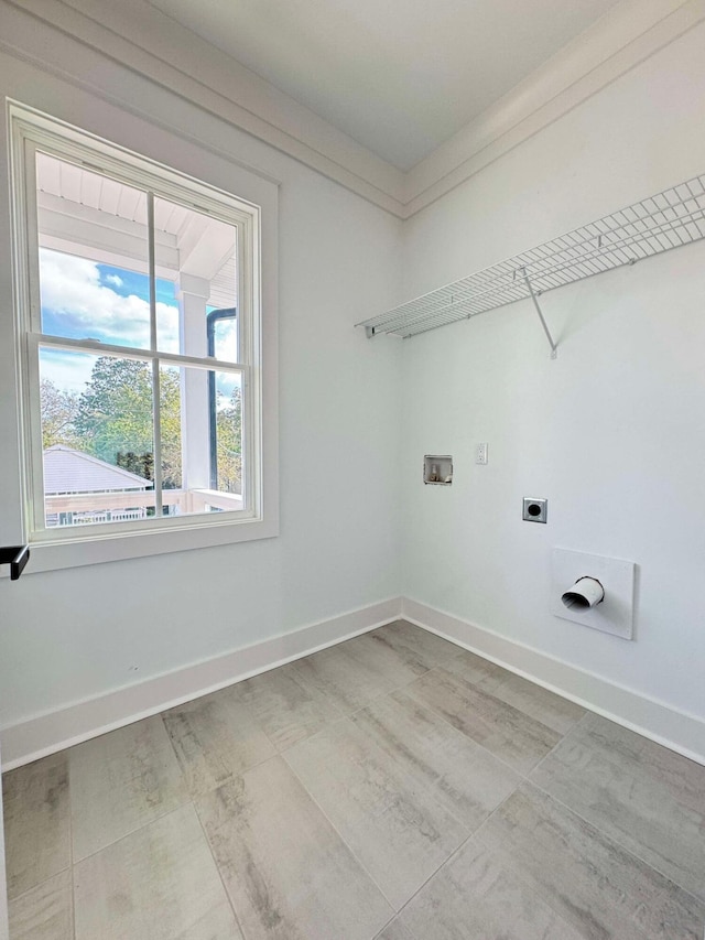 clothes washing area with hookup for a washing machine, ornamental molding, and electric dryer hookup