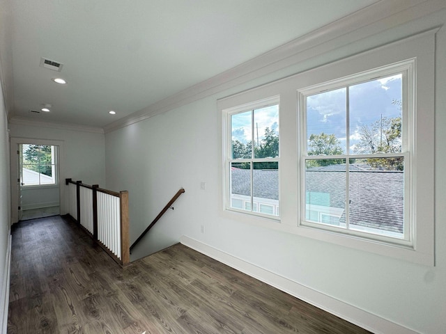 staircase featuring crown molding and hardwood / wood-style flooring