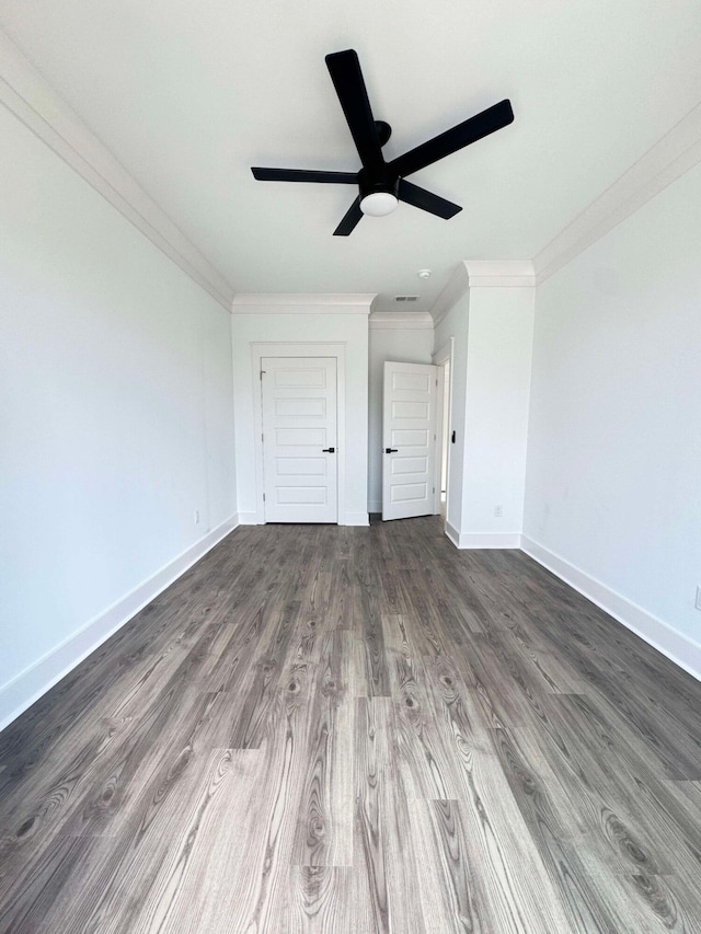 unfurnished bedroom featuring ceiling fan, dark hardwood / wood-style flooring, and ornamental molding