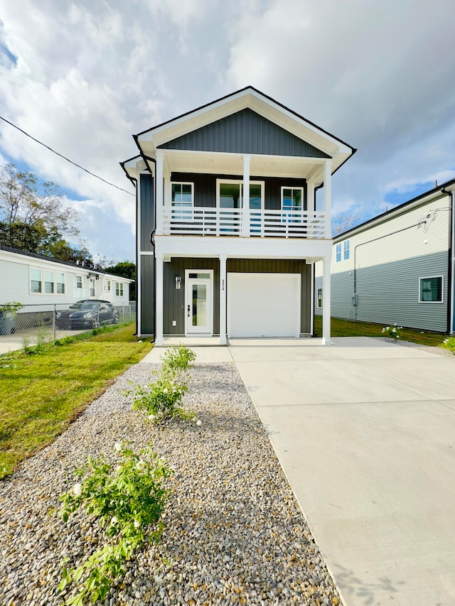 view of front of house featuring a balcony, a garage, and a front lawn