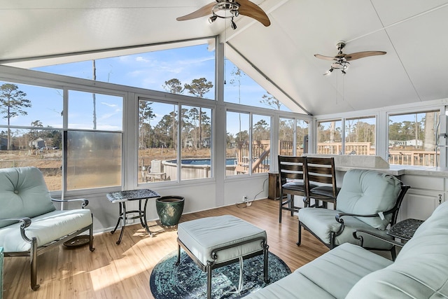 sunroom featuring ceiling fan and lofted ceiling