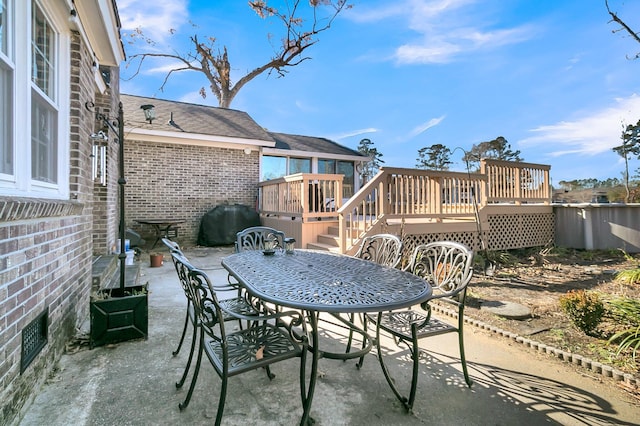 view of patio with area for grilling and a deck