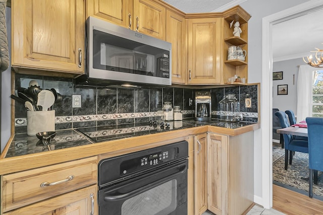 kitchen featuring black appliances, decorative backsplash, a notable chandelier, and ornamental molding