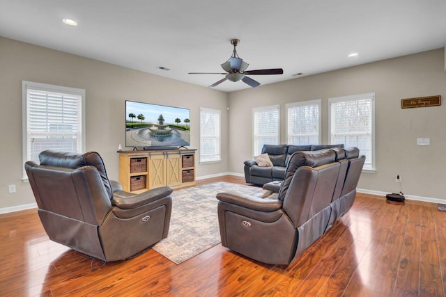 living room with recessed lighting, baseboards, and wood finished floors