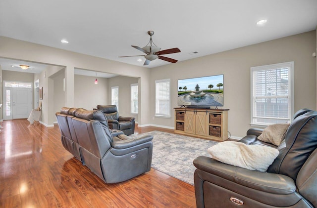 living room featuring recessed lighting, plenty of natural light, and wood finished floors