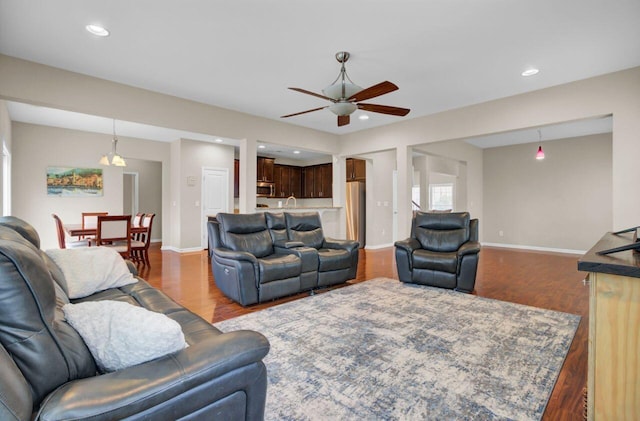 living area featuring recessed lighting, baseboards, and wood finished floors