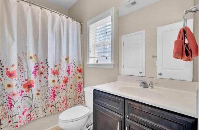 bathroom featuring shower / tub combo, visible vents, vanity, and toilet