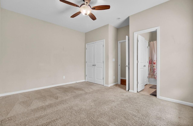 unfurnished bedroom with ensuite bathroom, carpet, a ceiling fan, and baseboards