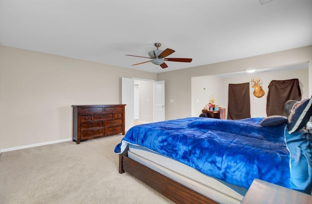 carpeted bedroom with ceiling fan and baseboards