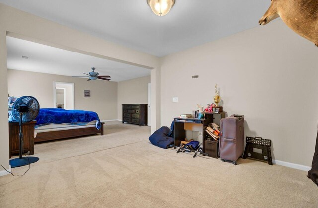 bedroom with carpet floors, a ceiling fan, and baseboards