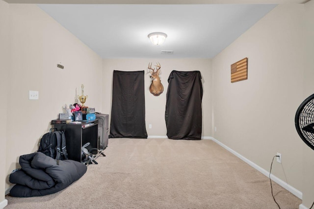 interior space with carpet flooring, visible vents, and baseboards