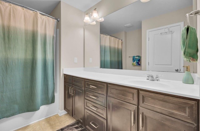 bathroom featuring shower / bath combo with shower curtain and vanity