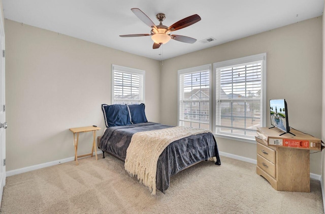 bedroom featuring light colored carpet, visible vents, ceiling fan, and baseboards