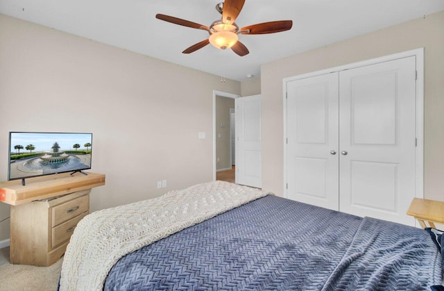 bedroom with carpet, a closet, and ceiling fan