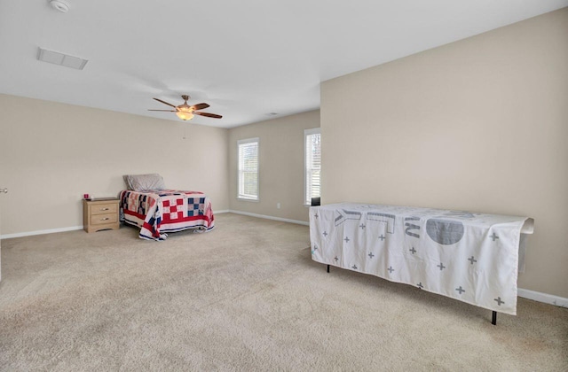 carpeted bedroom with baseboards and a ceiling fan