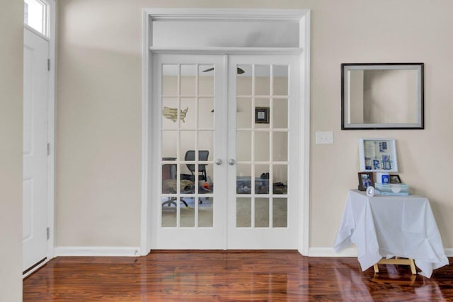 doorway with baseboards, wood finished floors, and french doors