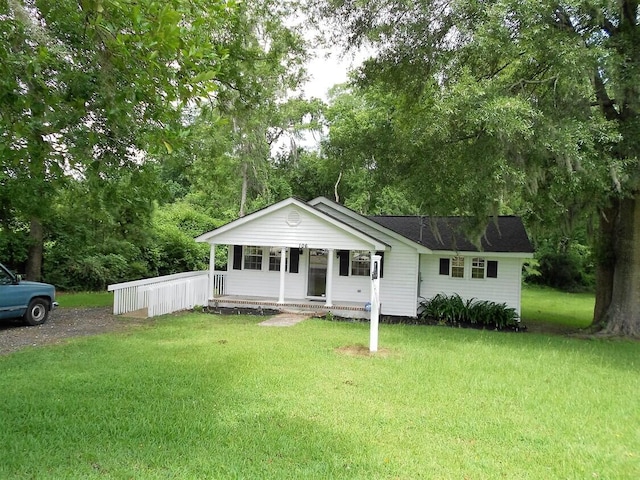 single story home with a porch and a front yard