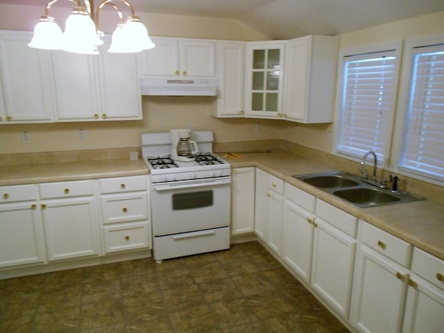 kitchen with white range with gas cooktop, dark tile floors, white cabinets, sink, and ventilation hood