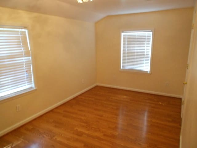 unfurnished room featuring hardwood / wood-style flooring and a wealth of natural light