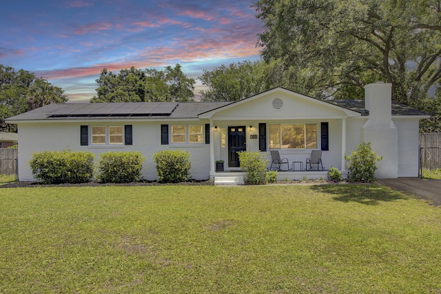 1032 Windward Rd, Charleston, SC 29412 - single story home with a porch, a chimney, roof mounted solar panels, and roof with shingles