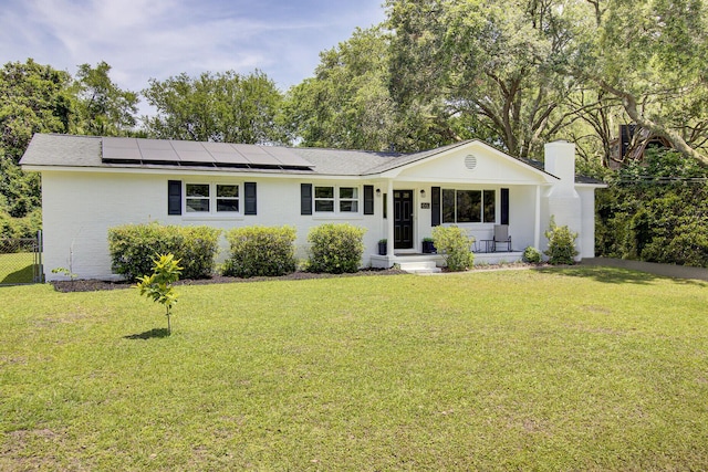 1032 Windward Rd, Charleston, SC 29412 - ranch-style house featuring roof mounted solar panels, a chimney, and covered porch