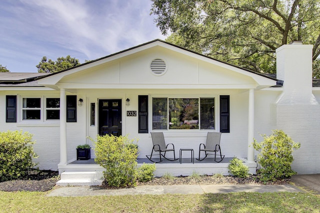 1032 Windward Rd, Charleston, SC 29412 - view of front of property featuring a porch, a chimney, and brick siding
