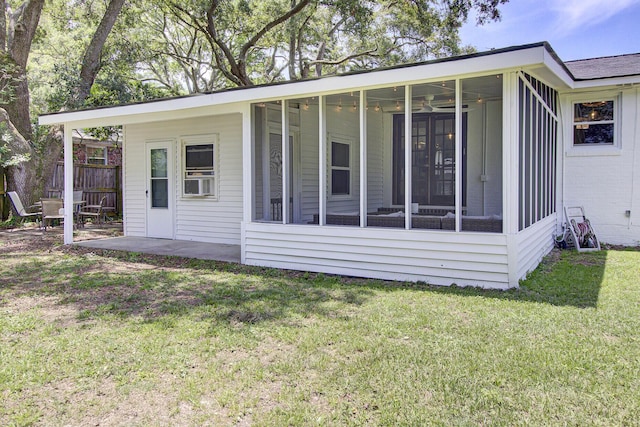 1032 Windward Rd, Charleston, SC 29412 - rear view of house featuring a sunroom, a lawn, a patio area, and brick siding