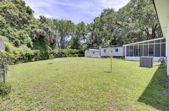 1032 Windward Rd, Charleston, SC 29412 - view of grassy yard with a storage shed, a sunroom, and view of scattered trees