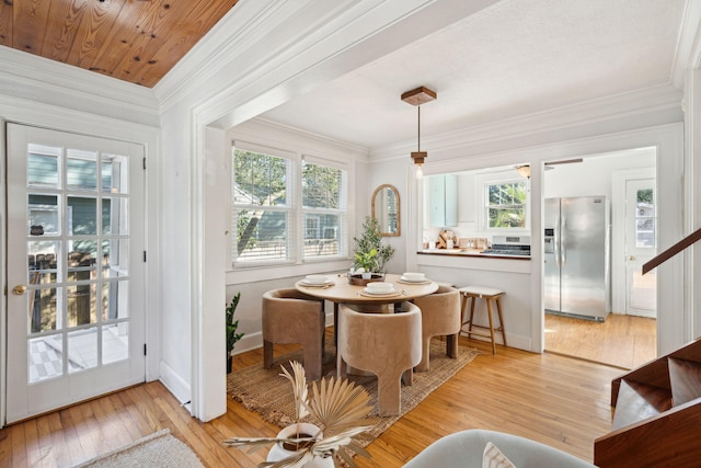 dining room with light hardwood / wood-style floors, plenty of natural light, and ornamental molding