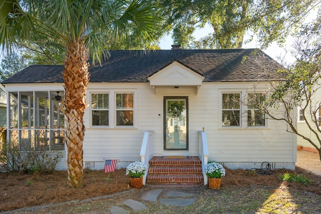 bungalow-style house featuring a sunroom