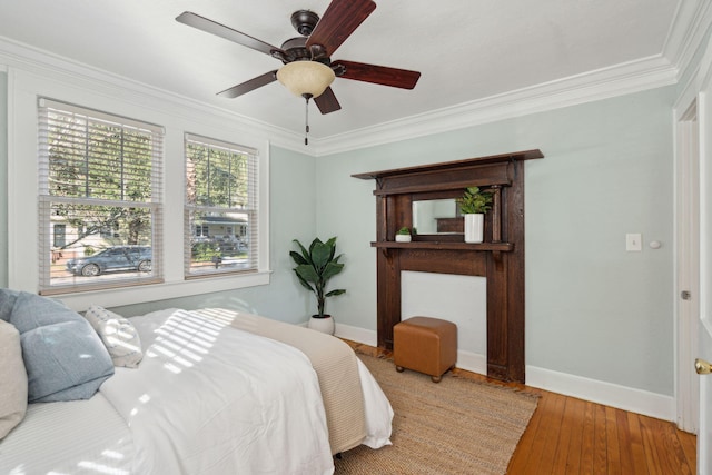 bedroom with wood-type flooring, ceiling fan, and crown molding