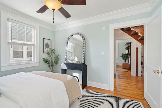 bedroom featuring multiple windows, ceiling fan, light hardwood / wood-style flooring, and crown molding