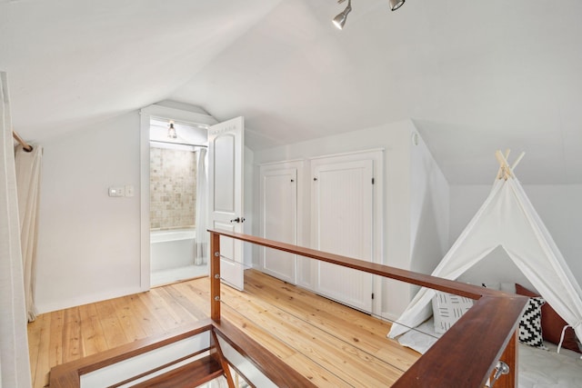 bonus room featuring hardwood / wood-style floors and vaulted ceiling