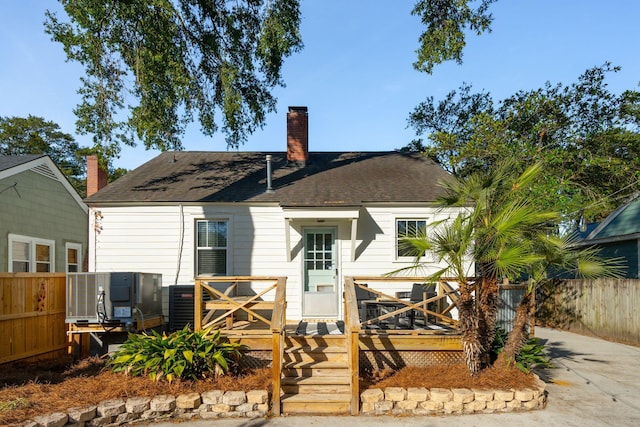 rear view of property featuring central AC unit