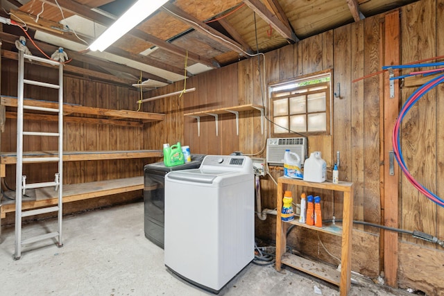 laundry room with wooden walls and a wall unit AC