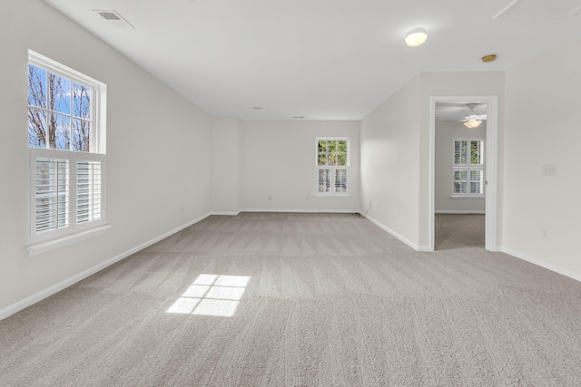 carpeted empty room featuring visible vents and baseboards